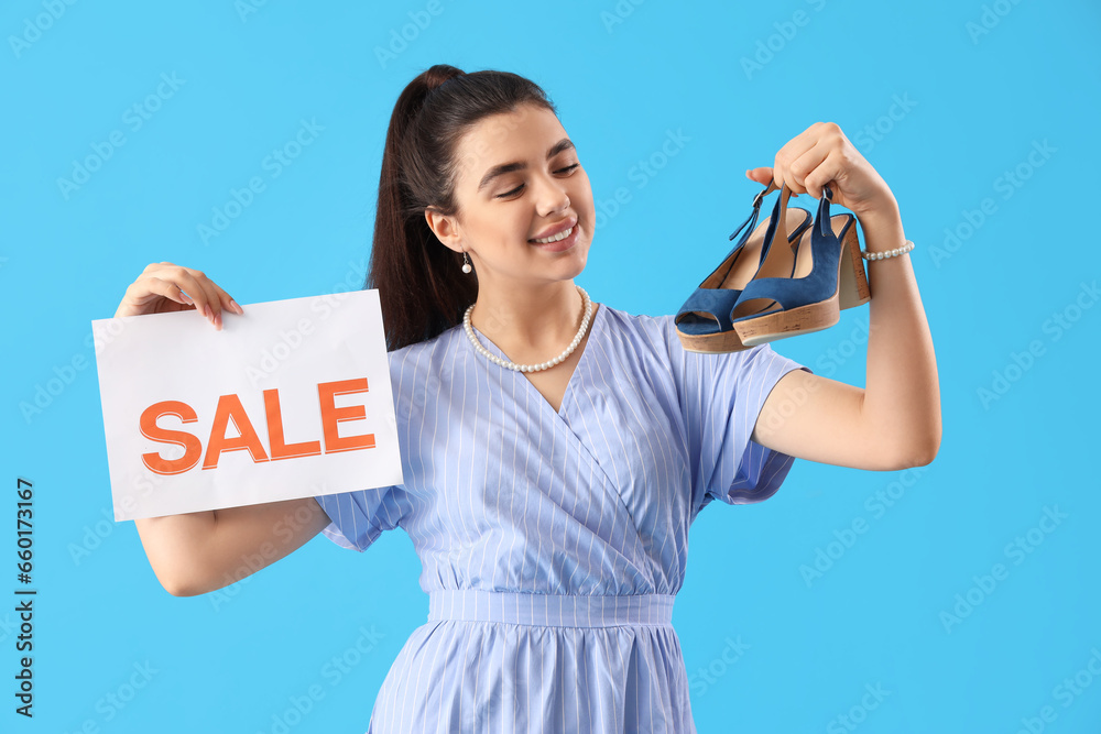 Female seller with sale sign and shoes on blue background