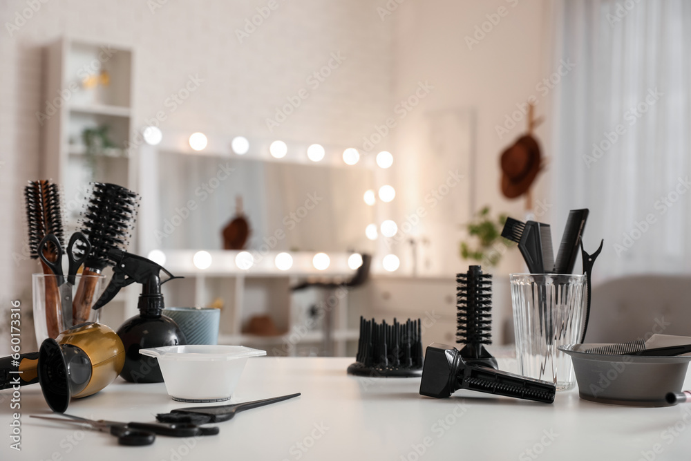 Different hairdressing tools on table in beauty salon