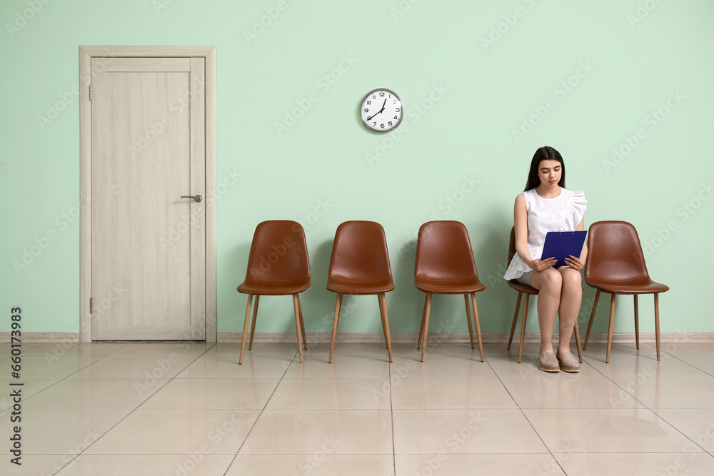 Young woman waiting for job interview in room