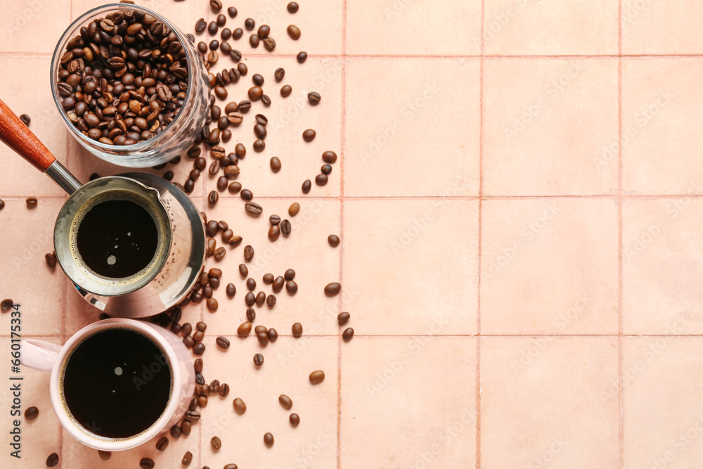 Cezve with cup of coffee and jar of beans on beige tile background