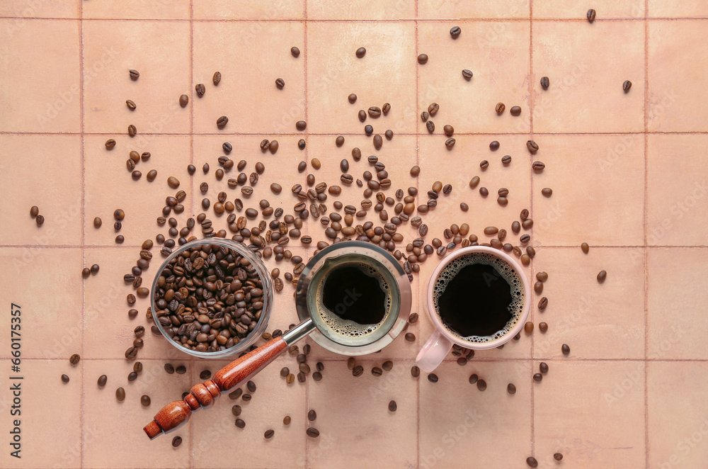 Cezve with cup of coffee and jar of beans on beige tile background