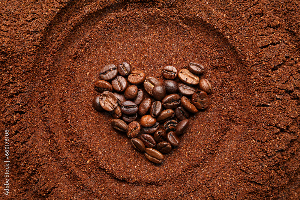 Heart made of coffee beans and powder as background