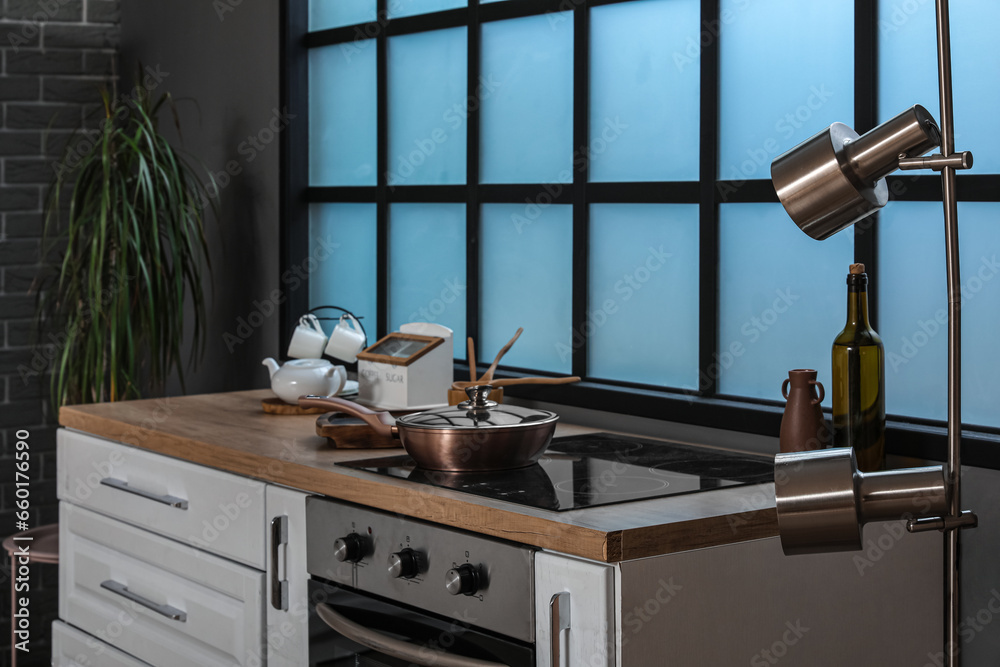 Kitchen counters with electric stove, oven and frying pan