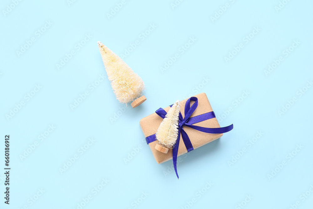 White Christmas trees with gift box on blue background