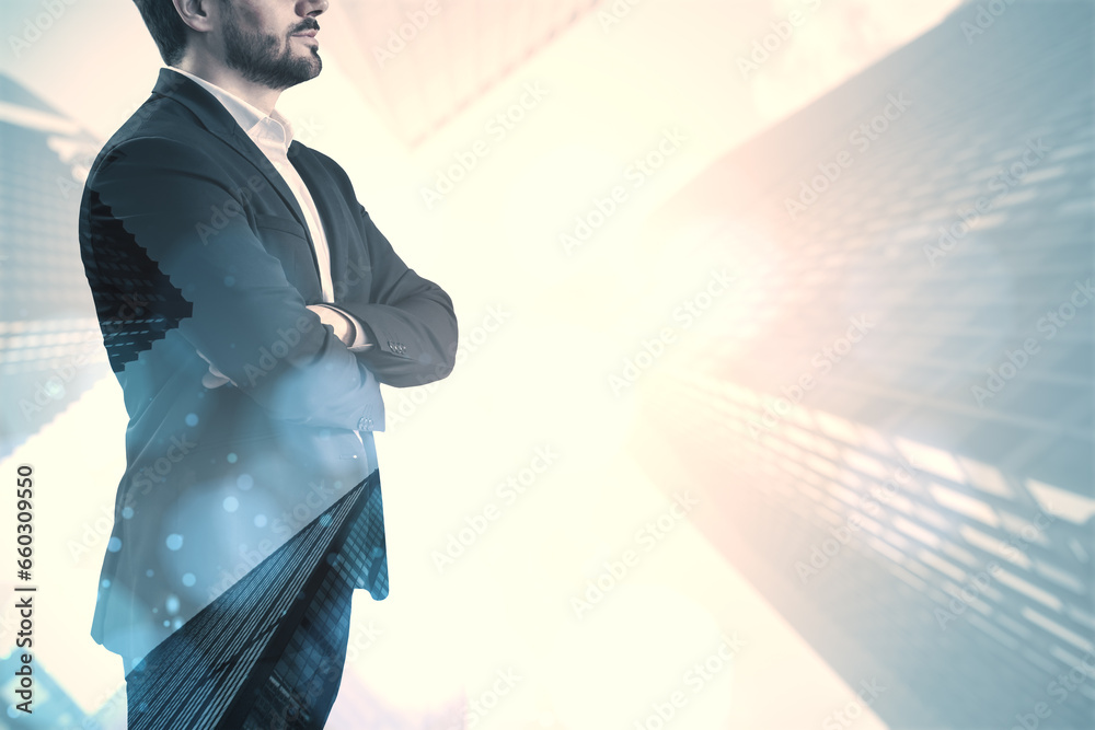 Young thoughtful man with folded arms standing on white bright city background with mock up place. Future, success and career concept. Double exposure.