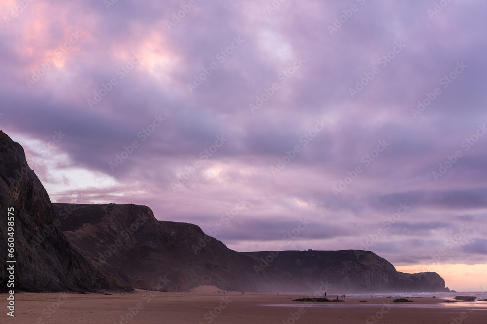 Sunset at sandy Cordoama Beach at Atlantic Ocean, Algarve, Portugal