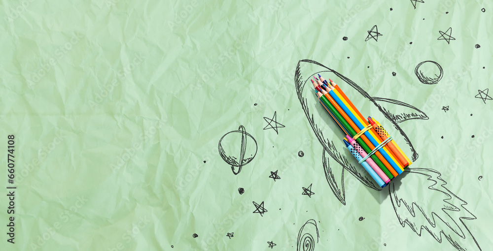 Back to school theme with hand drawn rocket and colored pencils - crumpled paper background