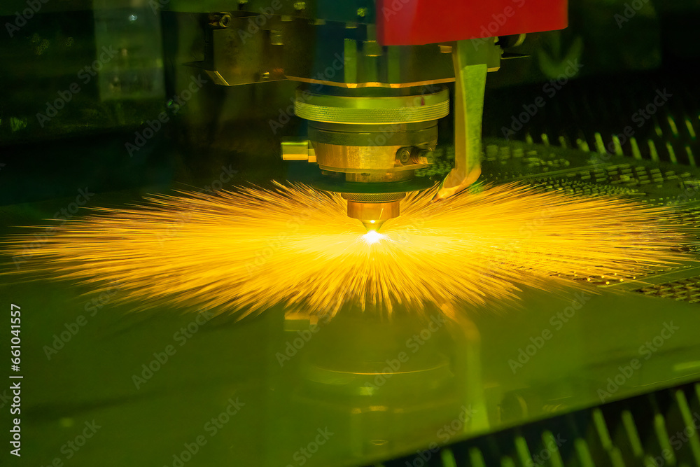 The fiber laser cutting machine  cut the metal plate with the sparkling light.