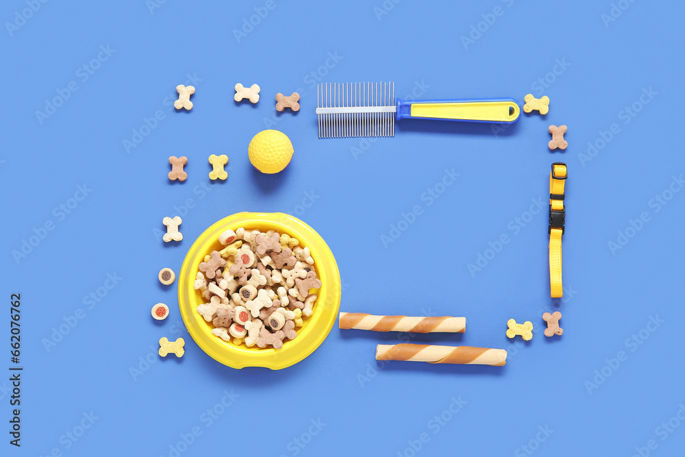 Frame made of pet care accessories and food on blue background