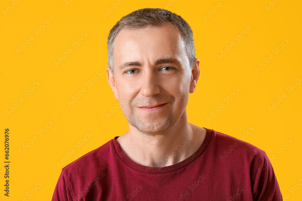 Portrait of handsome mature man on orange background