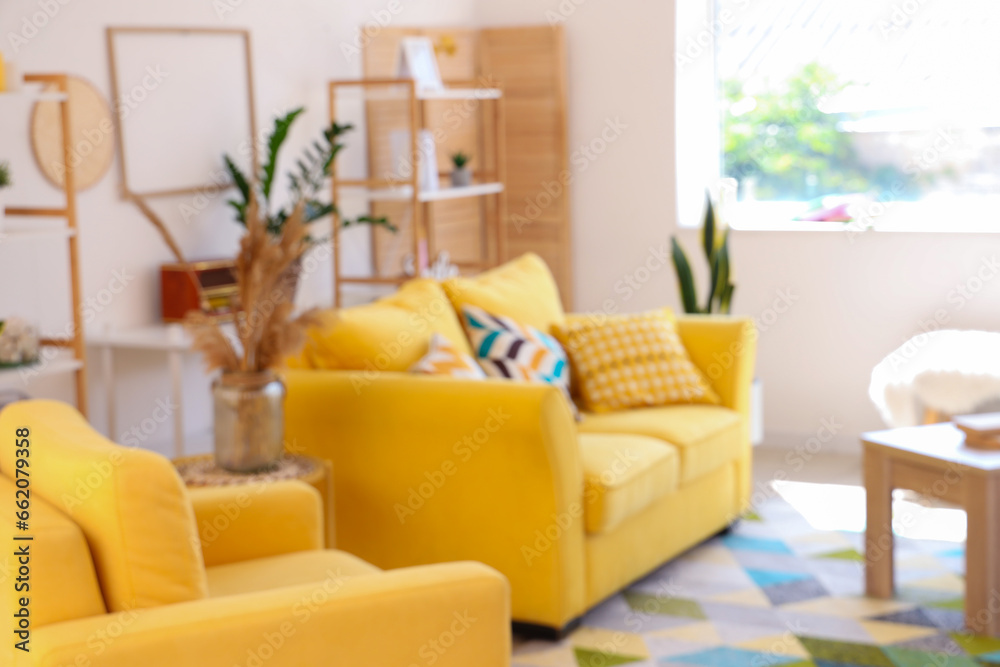 Interior of light living room with yellow sofa