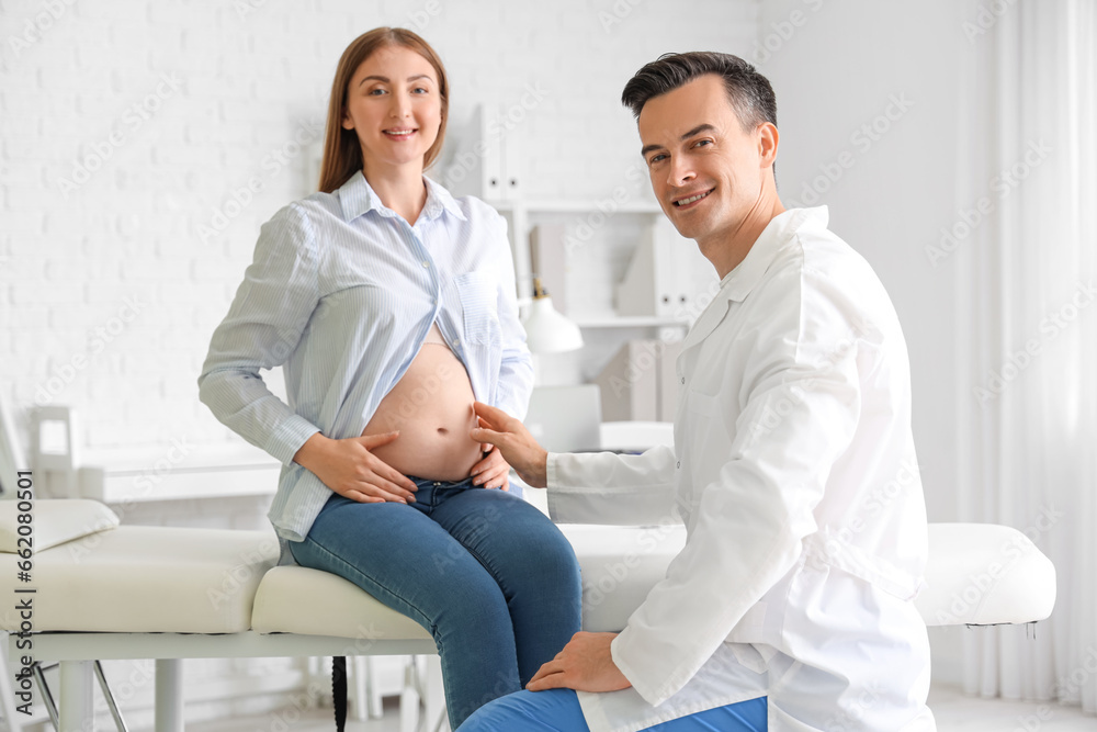 Young pregnant woman visiting doctor in clinic