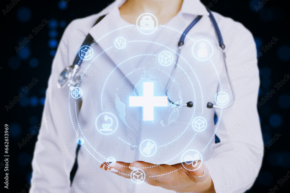 Close up of female doctor hand holding creative glowing blue medical hologram with cross and globe on blurry background. Science, healthcare system and futuristic pharmacy concept.