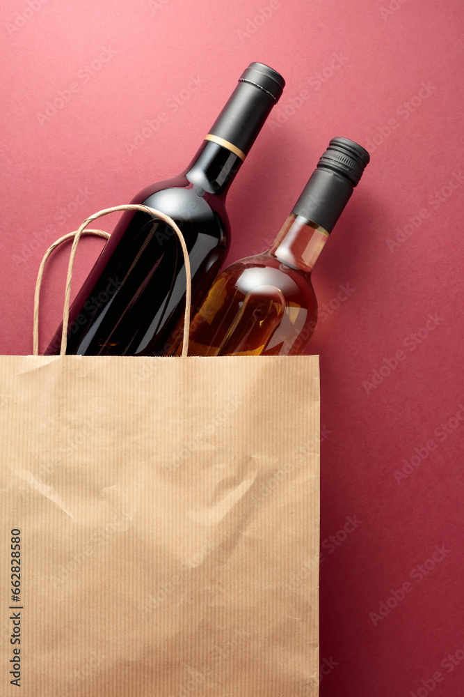 Recycled paper shopping bag with bottles of red and white wine.