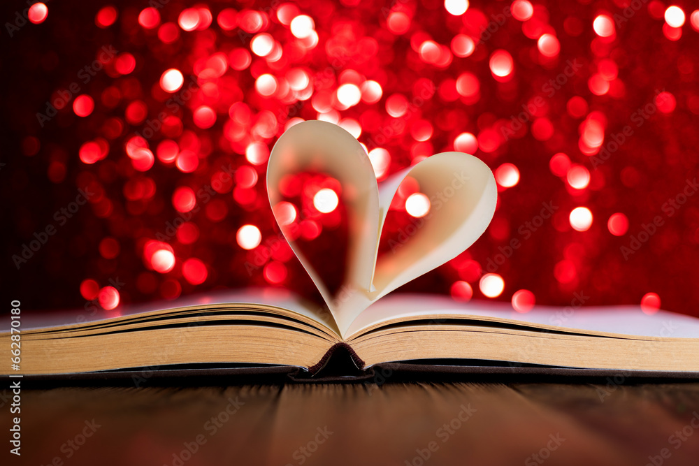 Heart shaped book pages on shiny background