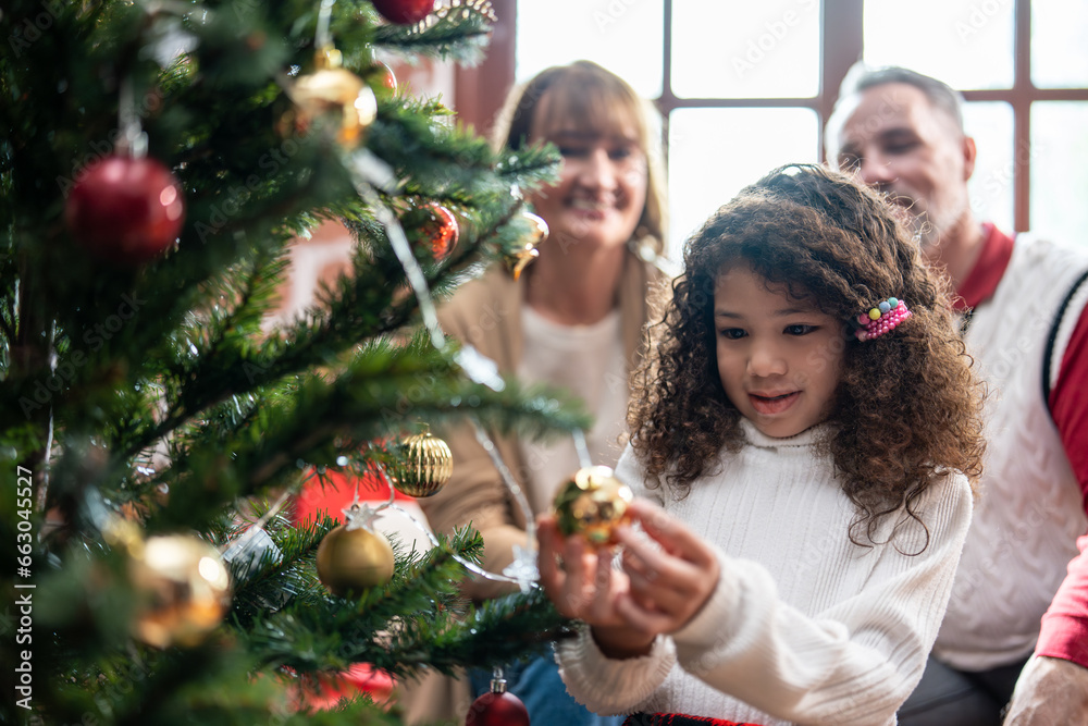 Caucasian family and kid daughter decorating Christmas tree in house. 