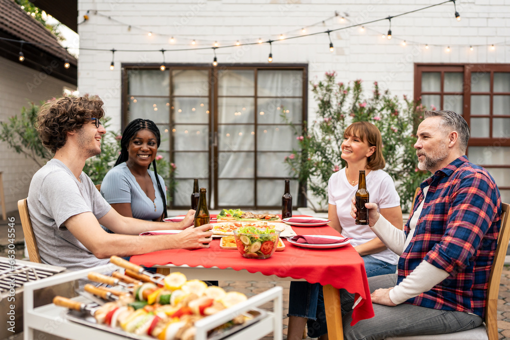 Multi-ethnic family having fun, enjoy party outdoors in the garden. 