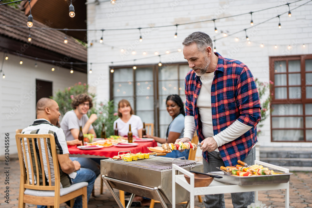 Multi-ethnic family having fun, enjoy party outdoors in the garden. 