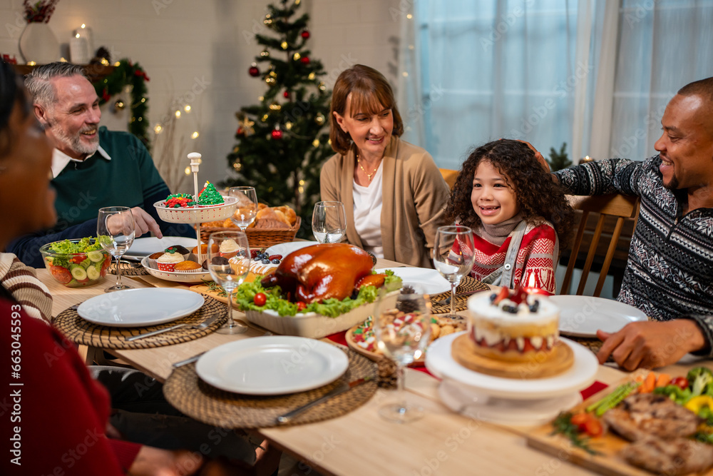 Multi-ethnic big family celebrating Christmas party together in house. 