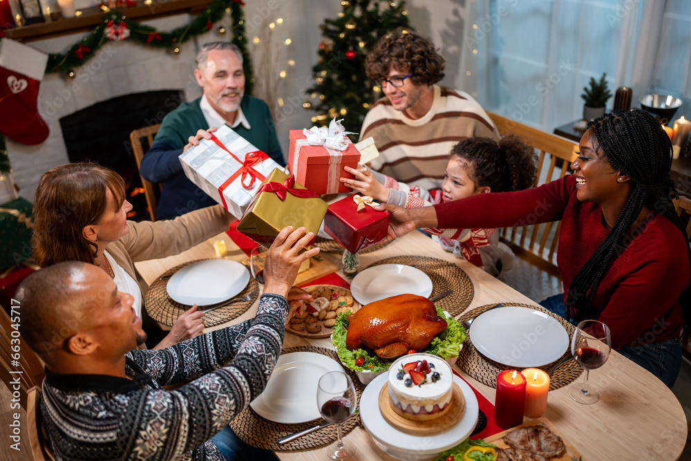 Multi-ethnic family exchanging presents during Christmas party at home. 