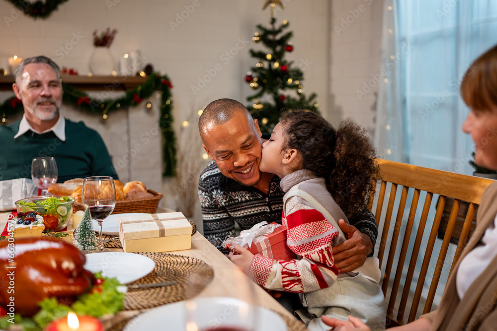 Multi-ethnic big family celebrating Christmas party together in house. 