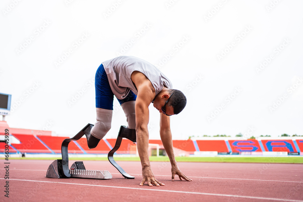 Asian para-athletes disabled with prosthetic blades running at stadium. 