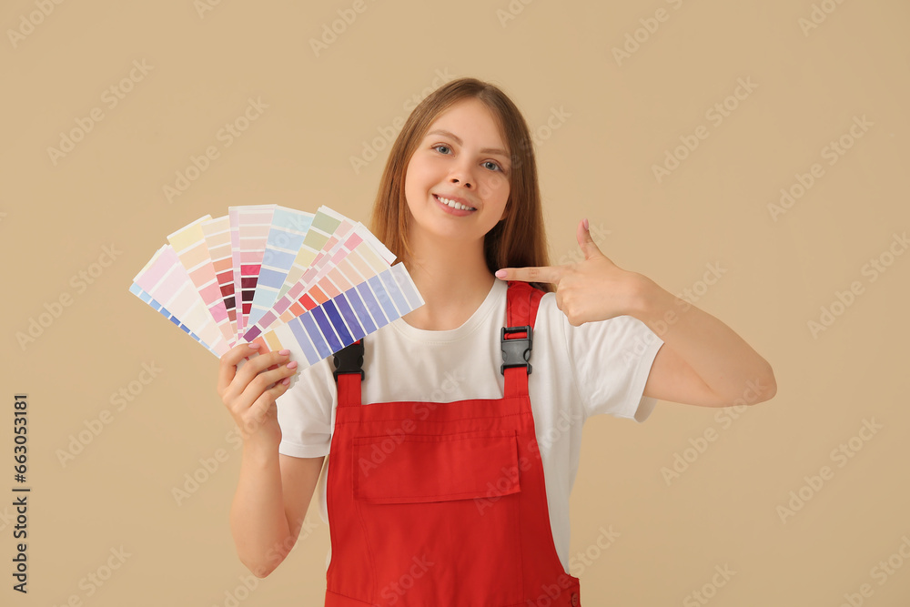 Female decorator with color samples on beige background