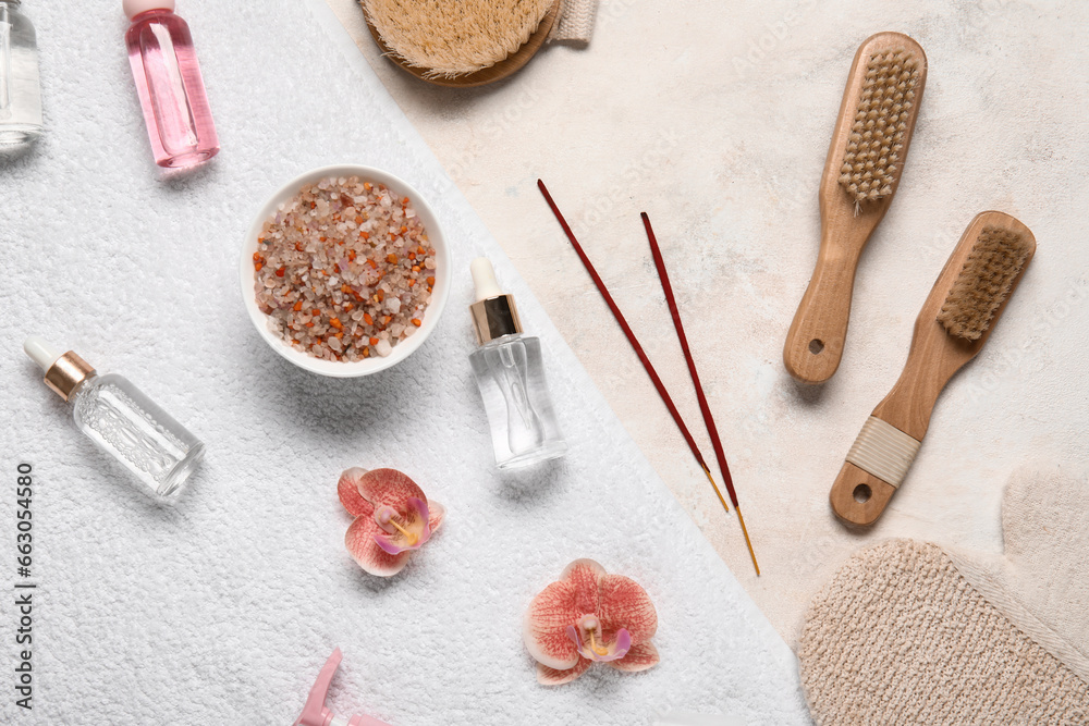 Composition with spa accessories, cosmetic products and flowers on light background