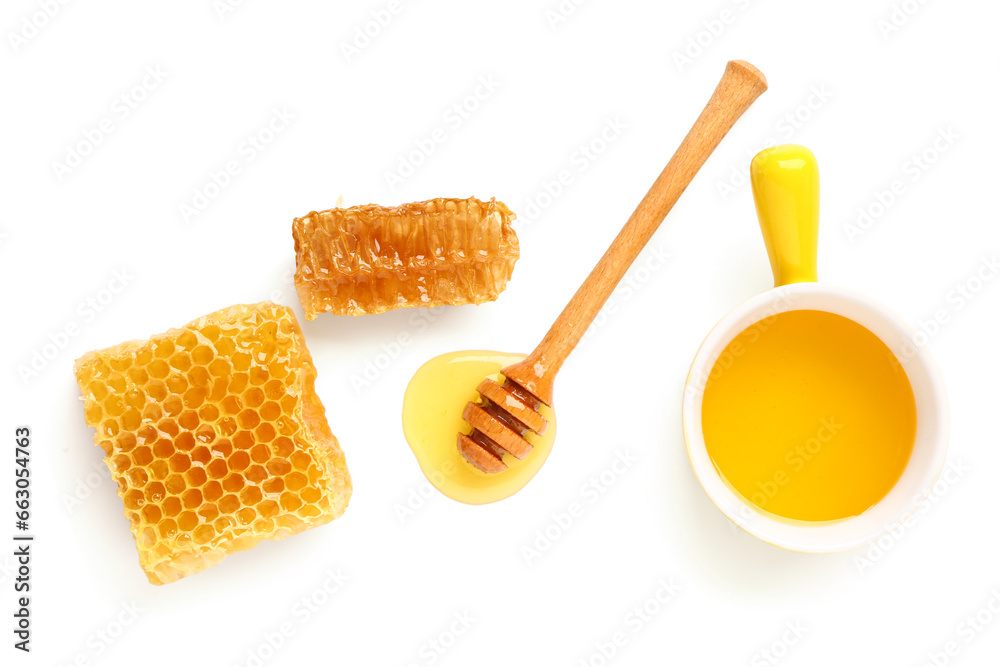 Bowl of sweet honey, dipper and combs on white background