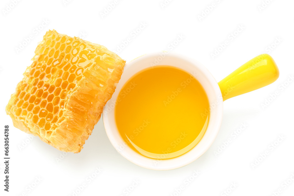 Bowl of sweet honey and comb on white background