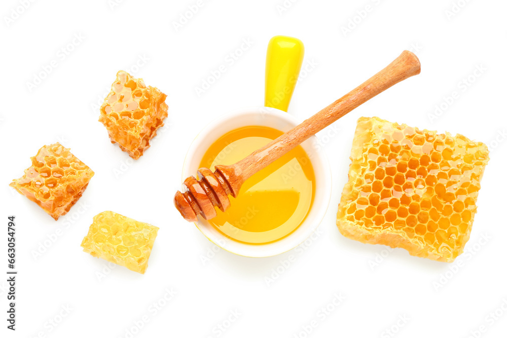 Bowl of sweet honey, dipper and combs on white background