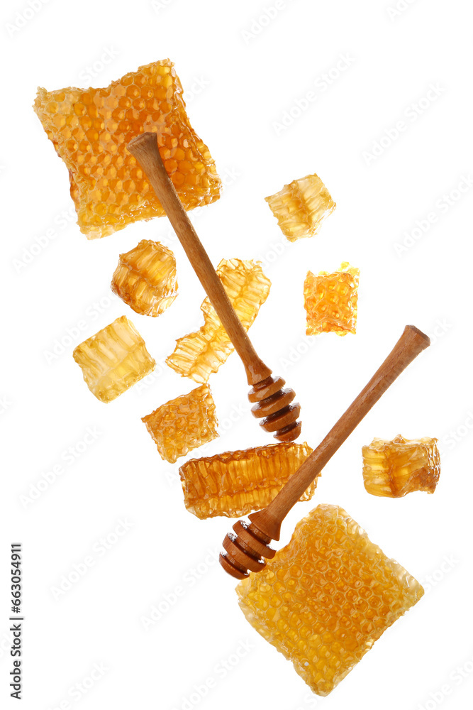 Flying sweet honeycombs and dippers on white background