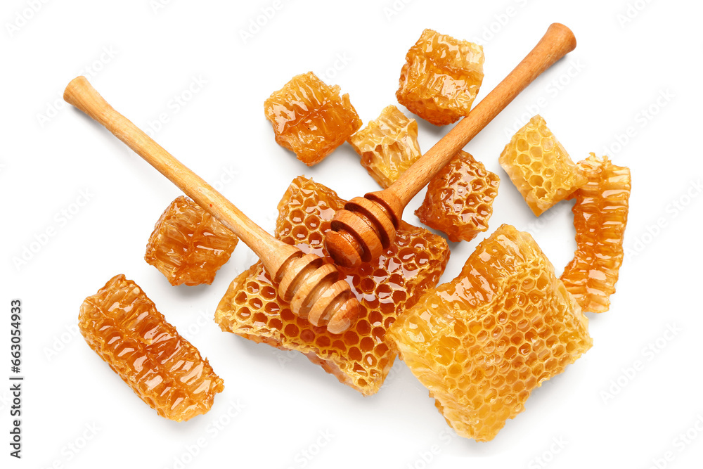 Sweet honeycombs and dippers on white background