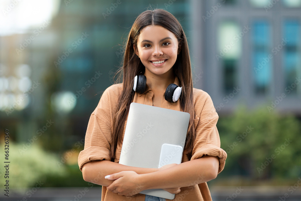 Energetic Young Lady Studying Outdoors, Holding Gadgets