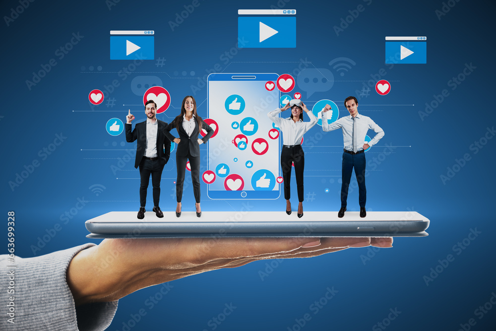 Close up of female hand holding tablet with a group of businesspeople with creative smartphone hologram, blue and red hearts on blue background. Social media, likes and digital marketing concept.