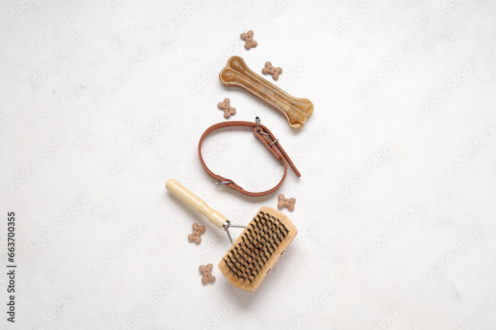 Composition with pet collar, grooming brush and food on light background