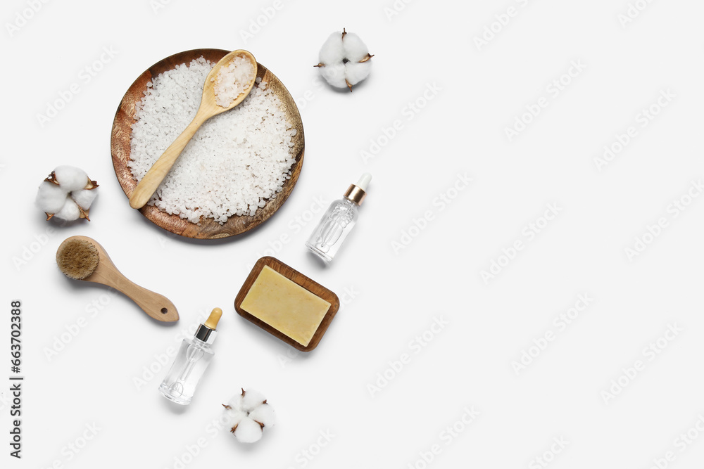 Composition with bath supplies and cotton flowers on white background