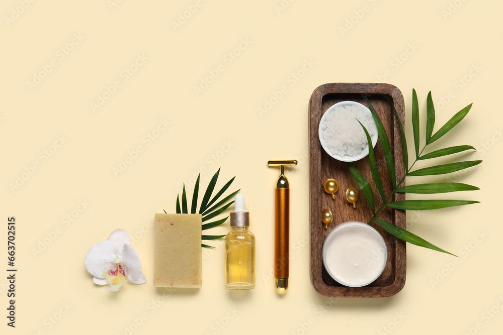 Composition with bath supplies and palm leaves on color background