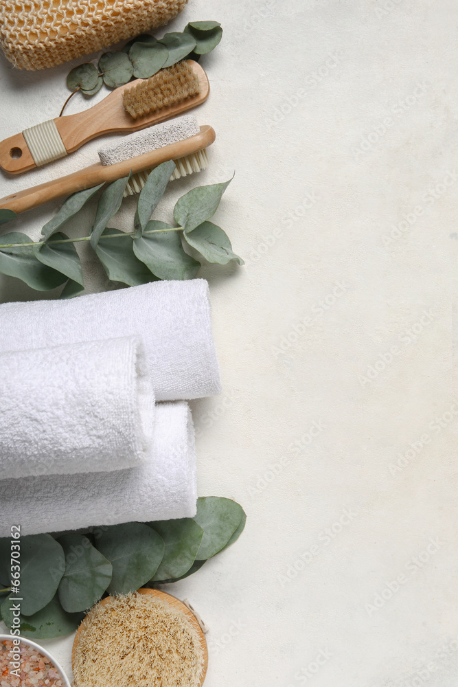 Composition with different spa accessories and eucalyptus branches on light background