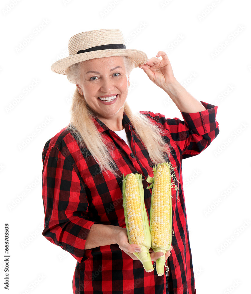 Mature female farmer with ripe corn cobs isolated on white background