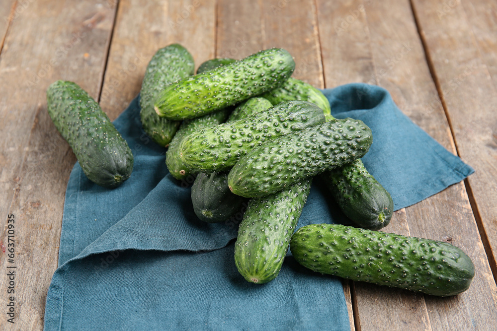 Heap of fresh cucumbers on wooden background