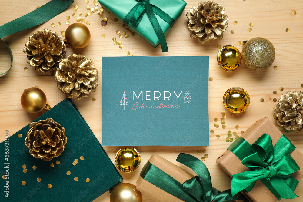 Greeting card with text MERRY CHRISTMAS, gift boxes and decor on wooden background