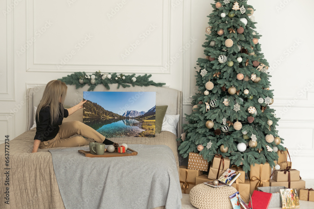 Female holds canvas, Christmas concept. White canvas board and Christmas decoration.