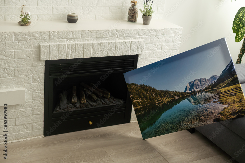 Canvas photo print on wooden floor. Sample of gallery wrapping method of canvas stretching on stretcher bar. Corner and edge of colorful photography closeup