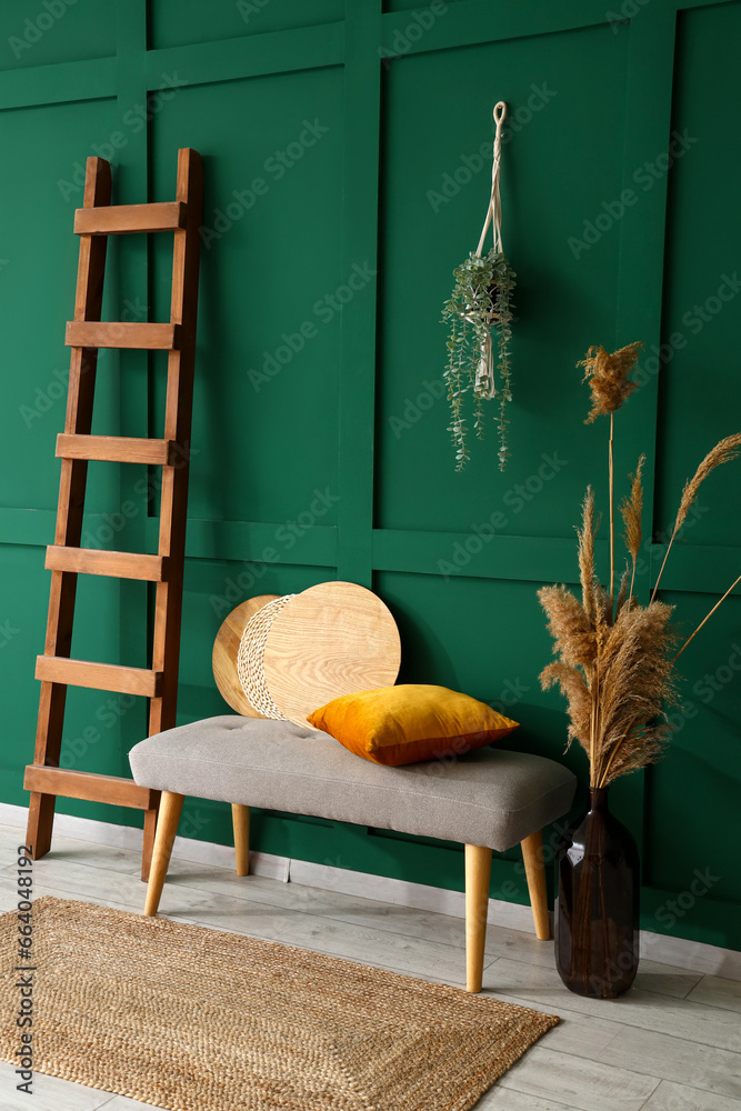 Interior of stylish room with soft bench and ladder