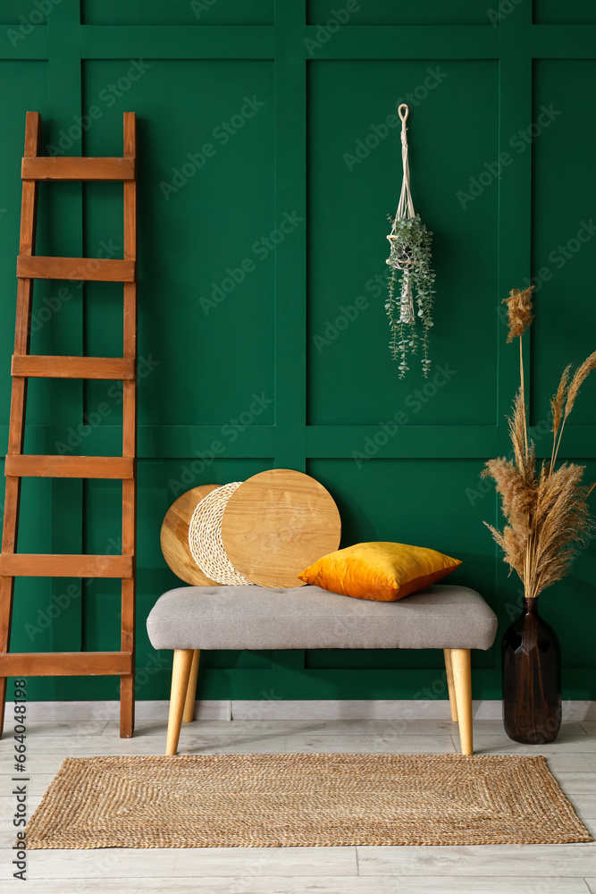 Interior of stylish room with soft bench and ladder