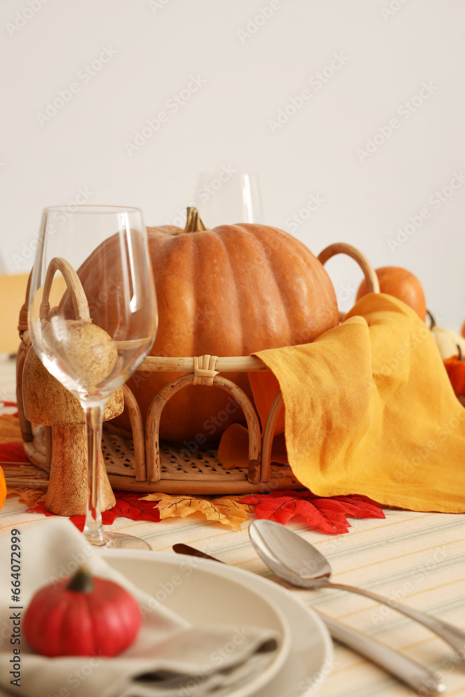 Festive table setting for Thanksgiving Day with pumpkins, napkins and cutlery