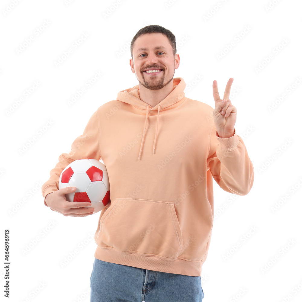 Man with soccer ball showing victory gesture on white background