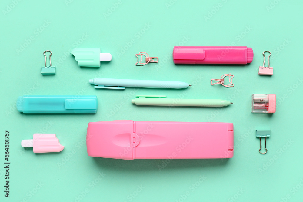 Pencil case with different stationery on turquoise background