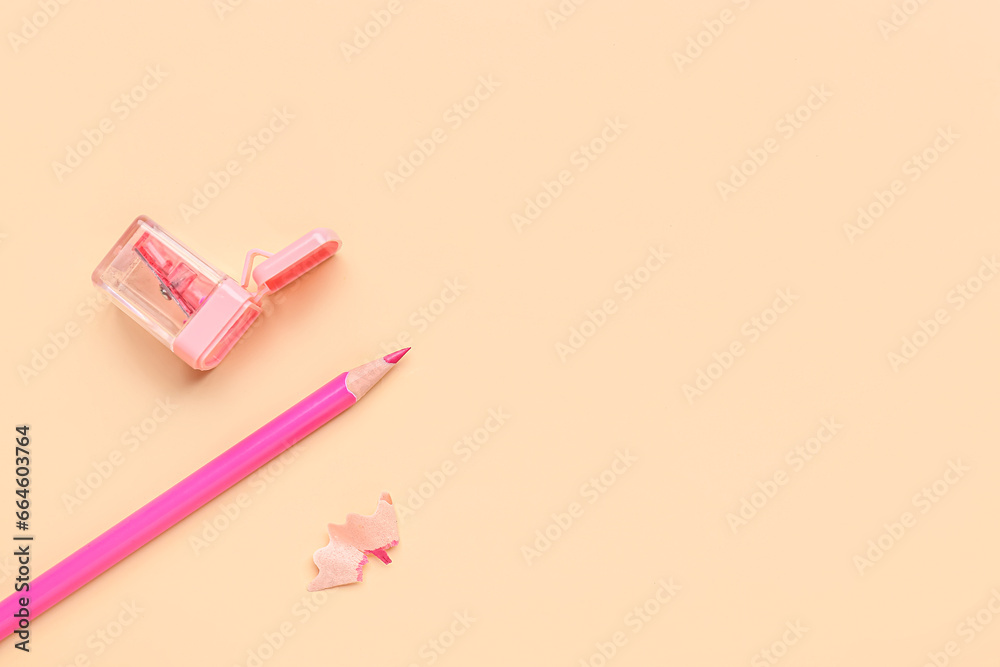 Sharpener with pencil on color background